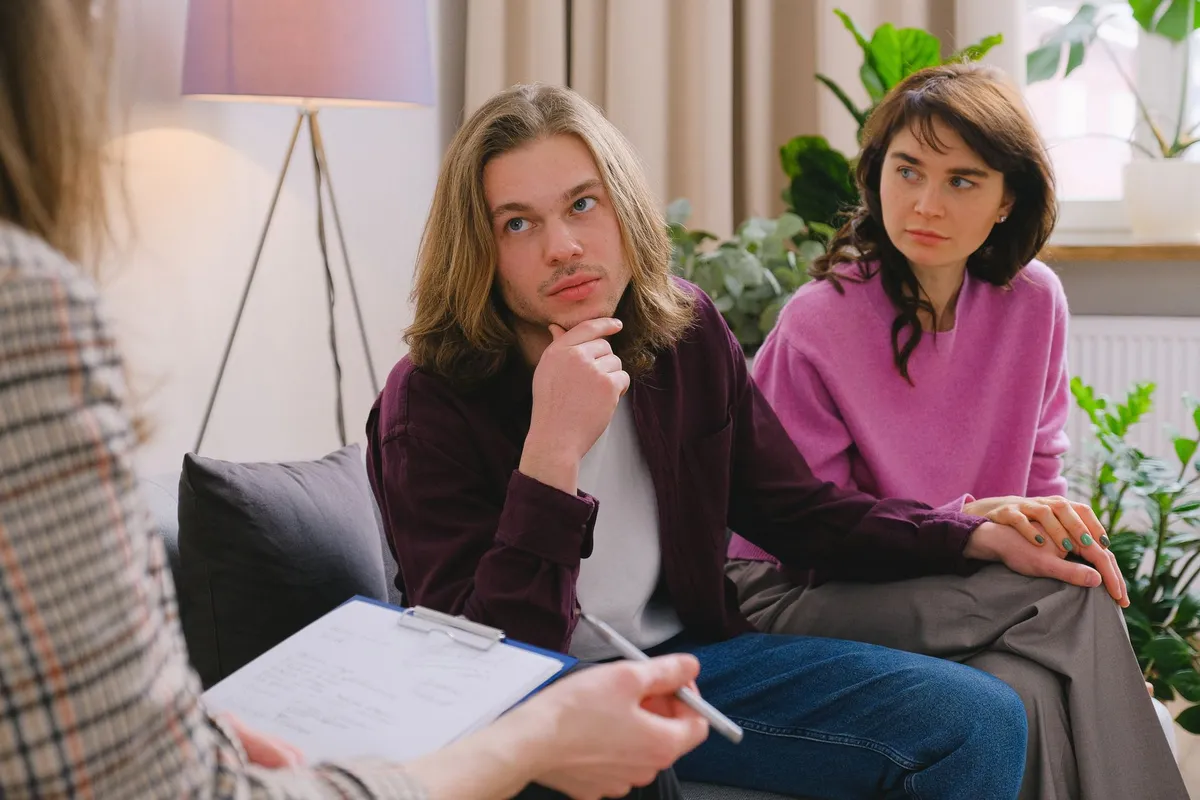 A couple in a couples therapy session working through betrayal trauma