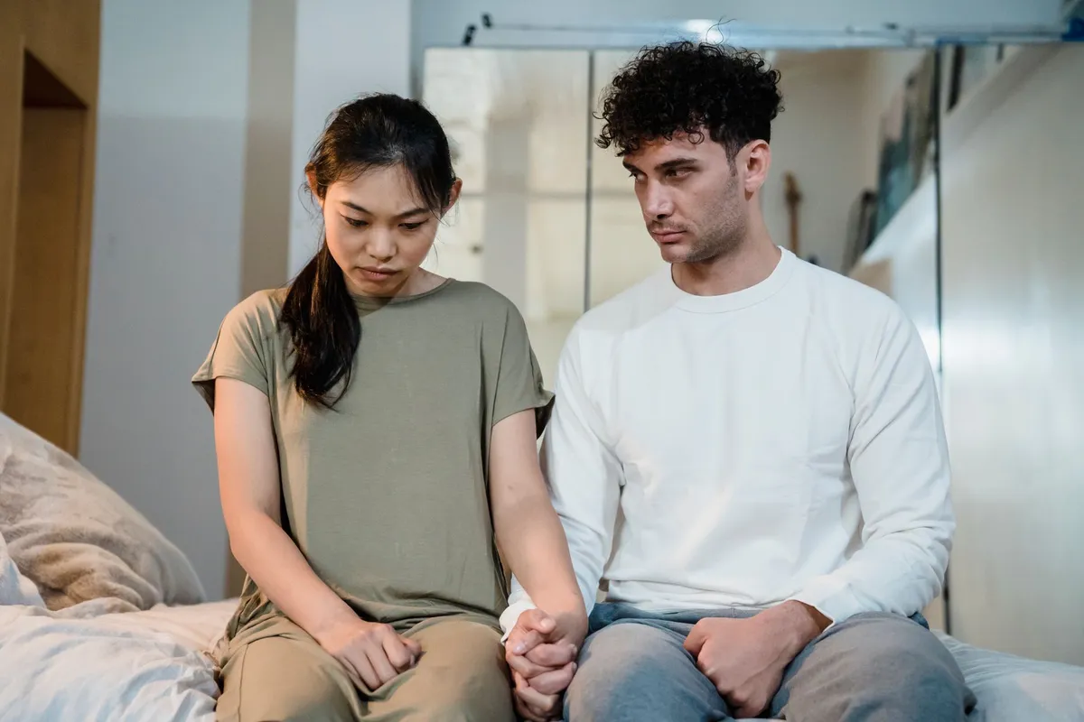 A couple sitting close together, a sign of readiness for couples therapy for betrayal trauma