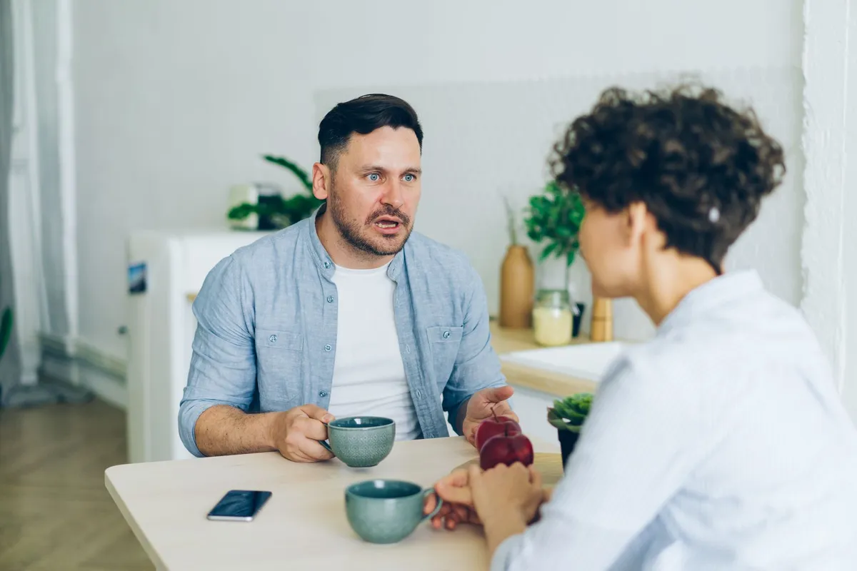 A couple talking honestly at home, doing the daily work of rebuilding trust in a relationship