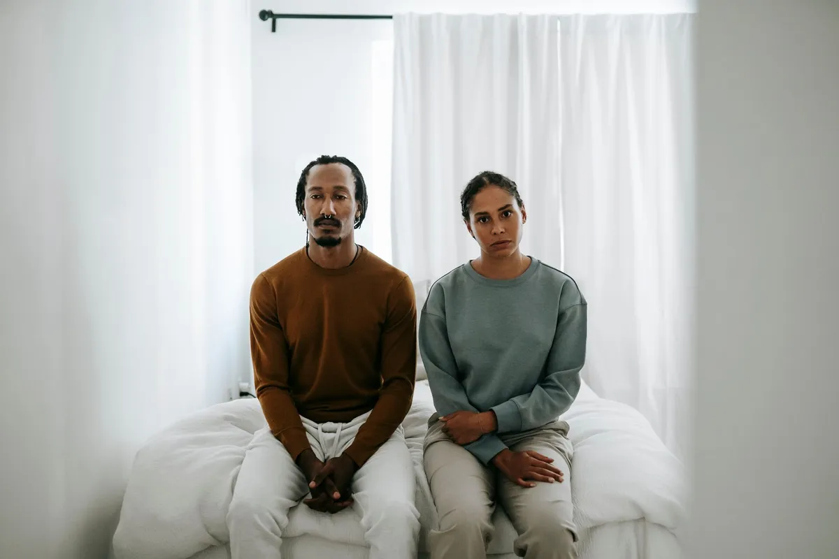 A couple sitting together, doing the slow work of rebuilding trust after betrayal