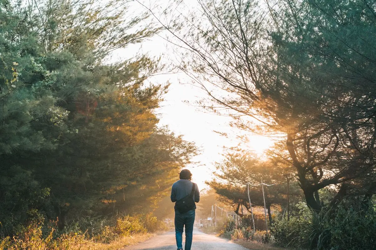 A man walking a path in morning light, doing the daily work of rebuilding trust