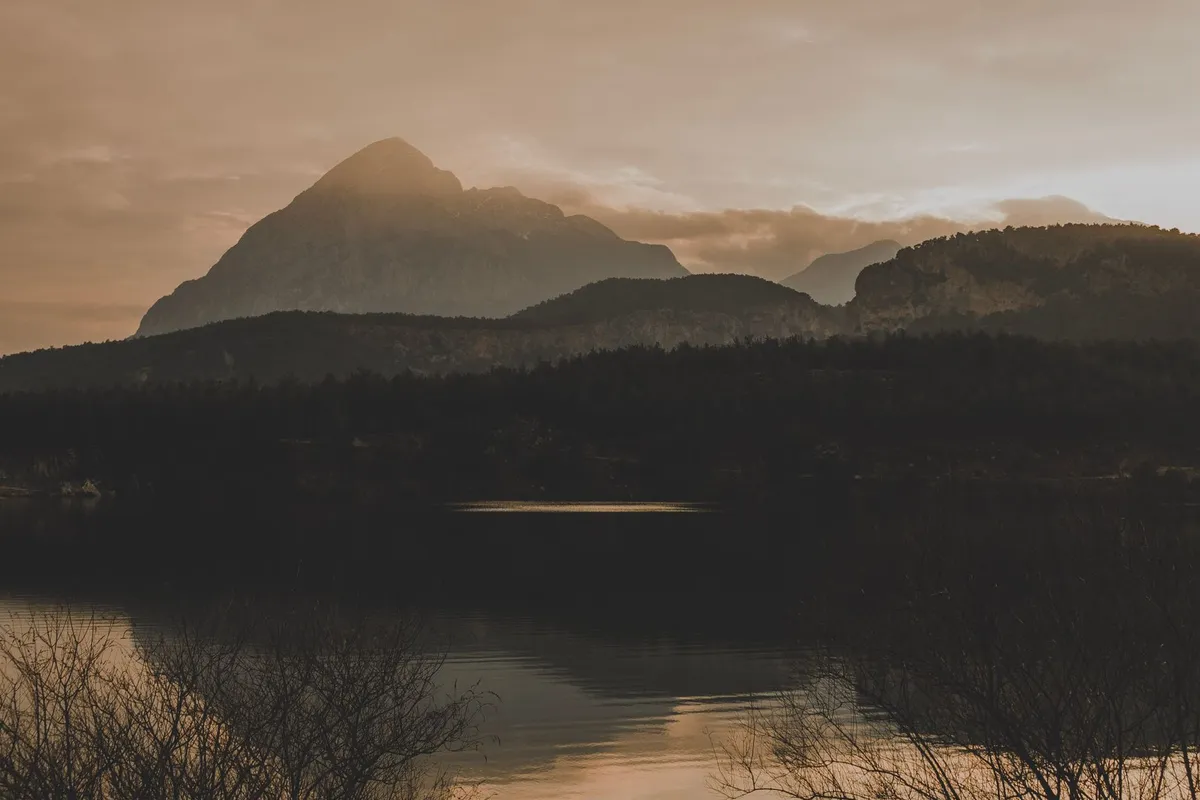 Still water at sunrise, an image of the slow consistency it takes for rebuilding trust in a relationship