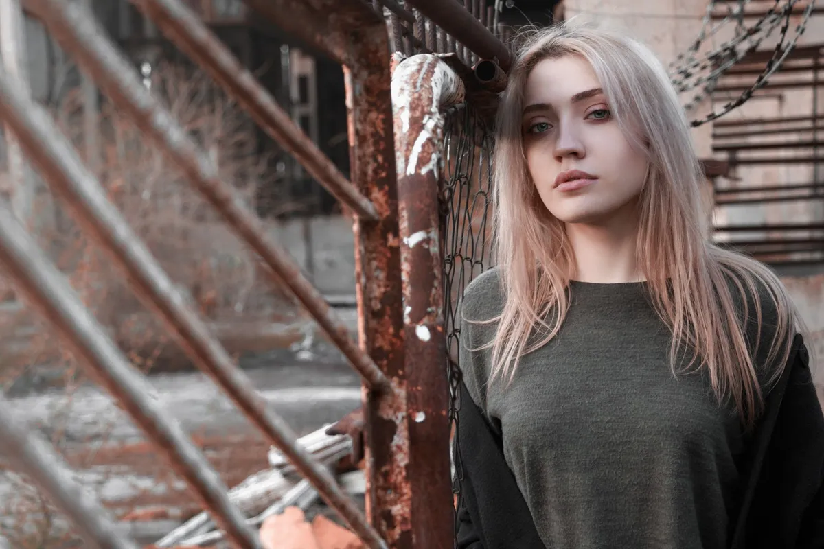 A woman looking away, thinking seriously, outdoors in daylight