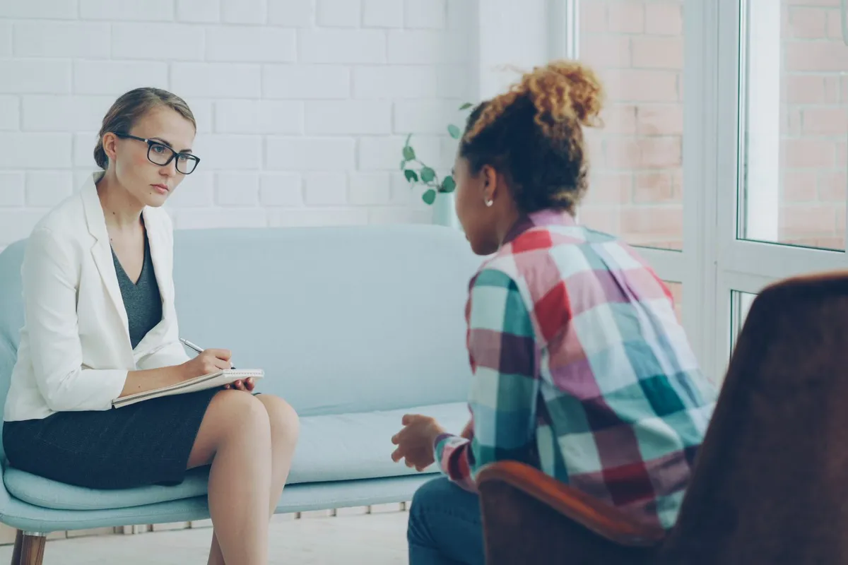 A woman in an individual session with a therapist for betrayal trauma