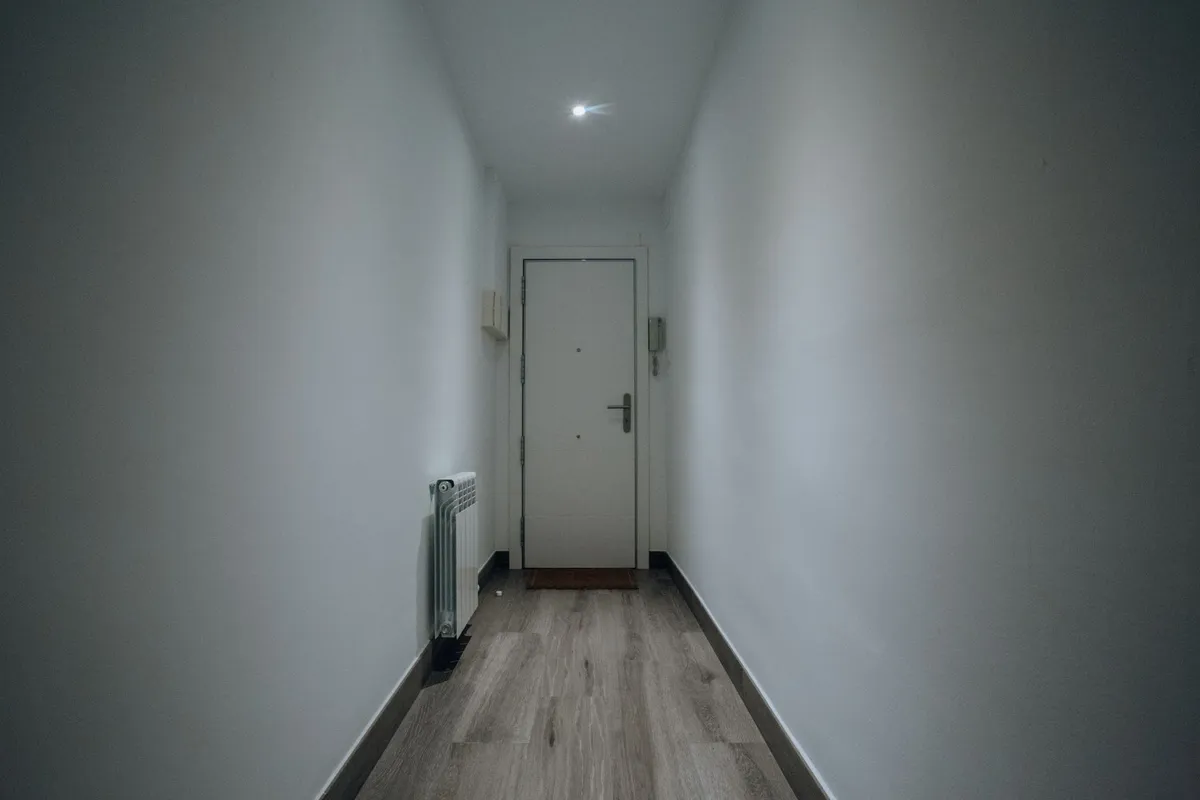 A packed suitcase by a front door, the sudden departure of walkaway husband syndrome